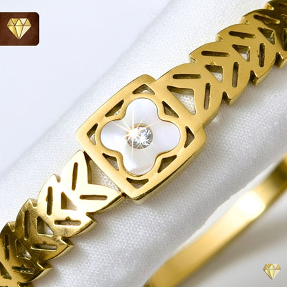 Gold-plated Kada bracelet with cut-out leaf motifs and mother-of-pearl clover centerpiece with cubic zirconia – Monica’s Jewel Studio