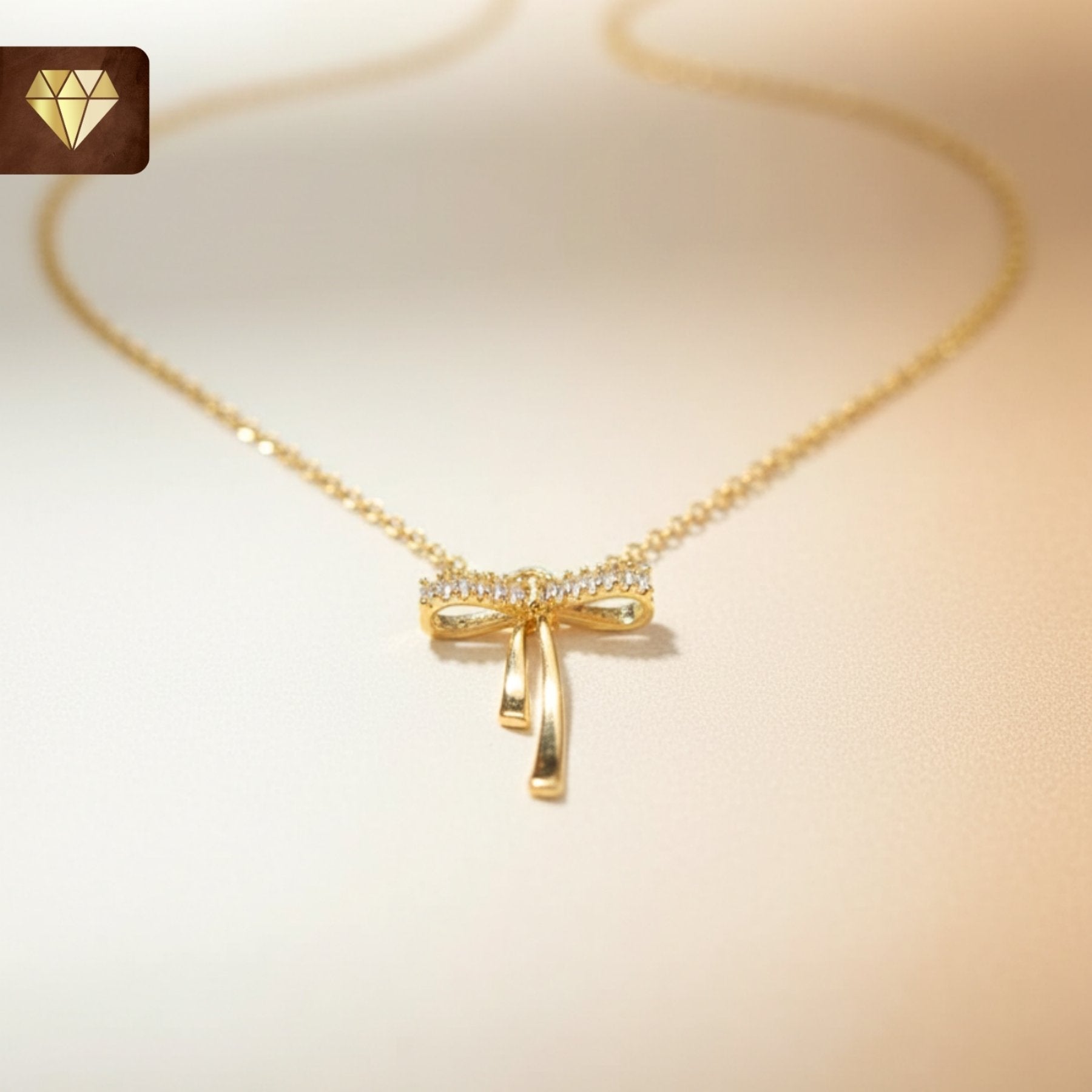 Gold-plated bow pendant necklace with AD (American Diamond) CZ stones for women